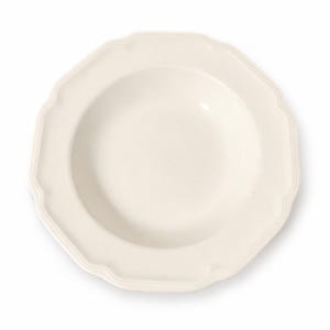 May include: A cream-colored ceramic soup bowl with a wide, scalloped rim and a smooth, glossy finish. The bowl features a circular center basin and a distinctively shaped, multi-sided edge that creates a decorative border around the main bowl area.