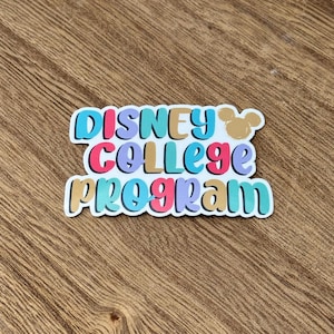 May include: A colorful sticker with the words "DISNEY COLLEGE PROGRAM" in a layered design. The text is in various colors, including pink, blue, gold, and teal, with a white outline. A small Mickey Mouse head icon is in the upper right corner.