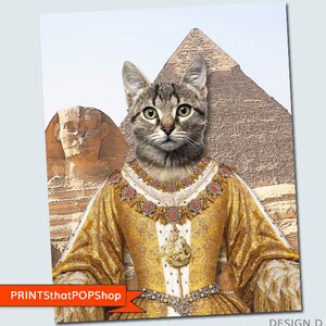 May include: A tabby cat dressed as a queen with a gold crown and robe, standing in front of the pyramids of Giza. The cat is looking directly at the viewer. The image is a digital illustration.