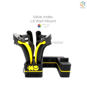 May include: A black wall mount for a Valve Index VR headset with yellow accents. The mount includes a space for two controllers and a cable management system. The text "Valve Index LX Wall Mount" and "Pick any Color" is visible on the mount. The text "Knuckles Palm Support (sold separately)" is also visible.
