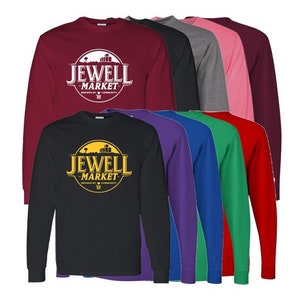May include: A collection of long-sleeved shirts in various colors, including black, burgundy, and pink. Each shirt features the "JEWELL MARKET" logo in a circular design. The shirts are made of a soft material and are suitable for casual wear.