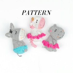 May include: Three crocheted animal figures: a donkey, a unicorn, and a hippo. The donkey is gray with blue shorts, the unicorn is white with a pink face and tutu, and the hippo is gray with a pink tutu. The word "PATTERN" is above the figures.