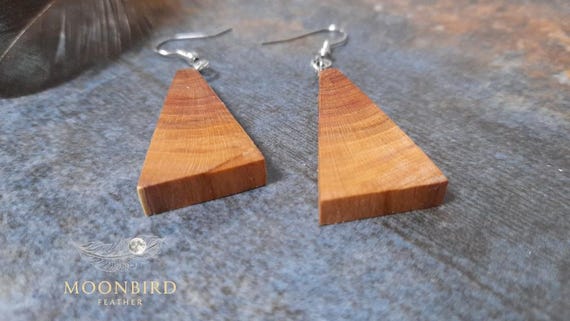 Handmade earrings made of plum wood.