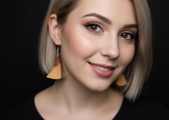 Handmade earrings made of plum wood.