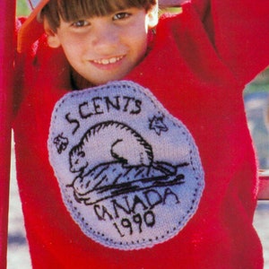 May include: A red knitted sweater with a white embroidered patch featuring a beaver and the text "SCENTS CANADA 1990". The sweater is worn by a young boy wearing a blue baseball cap and playing on a playground.