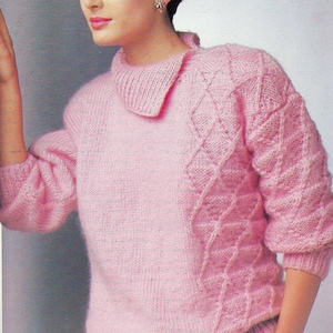 May include: A pink knitted jumper with a cable knit pattern and a collar. The jumper is shown on a model with short dark hair. The text "PDF Pattern" is at the bottom of the image.