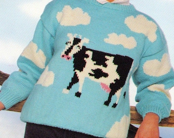 May include: A blue knitted sweater with a white cow and clouds design. The sweater has a crew neck and long sleeves. The text "Io" is in the top left corner of the image. The text "PDF Pattern" is at the bottom of the image.