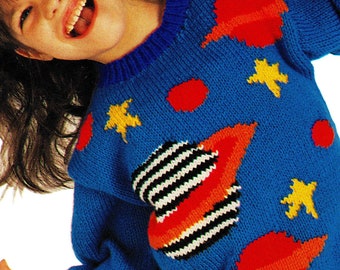May include: A blue knitted sweater with a colorful space-themed design. The sweater features red, orange, yellow, black, and white stripes and stars. The text "PDF Pattern" is at the top of the image.