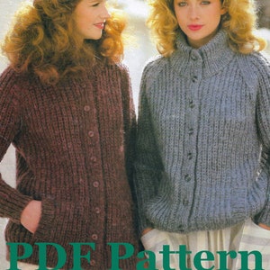 May include: Two women wearing knitted cardigans with button closures. The cardigan on the left is a deep burgundy color and the cardigan on the right is a light blue color. Both women are wearing hats.
