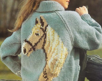 May include: A light blue knitted sweater with a brown and white horse design on the back.