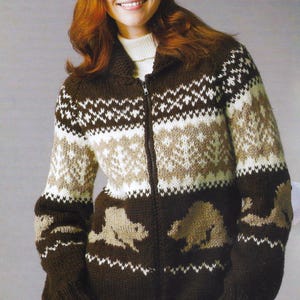 May include: A brown, beige, and white knitted zip-up sweater with a geometric pattern and bear silhouettes. The sweater has a high collar and is made of a thick, warm material, perfect for cold weather.