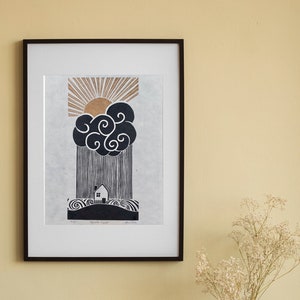 This lino print features a house on a hill surrounded by the sea. Above the house is a rain cloud pouring directly down onto the house. Out from the top of the cloud is a golden sun with it's rays beaming upward toward the top edges of the paper.