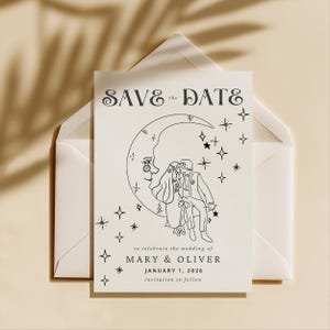 May include: A cream-colored "Save the Date" card with a black line drawing of a couple on a crescent moon, surrounded by stars. The card is inside a white envelope. The text reads "SAVE the DATE" and "MARY & OLIVER JANUARY 1, 2026".
