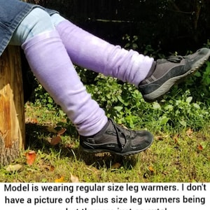 May include: Light purple leg warmers worn with black sneakers. The leg warmers are a soft, fuzzy material and are bunched up around the ankles. The text in the image says, "Model is wearing regular size leg warmers."
