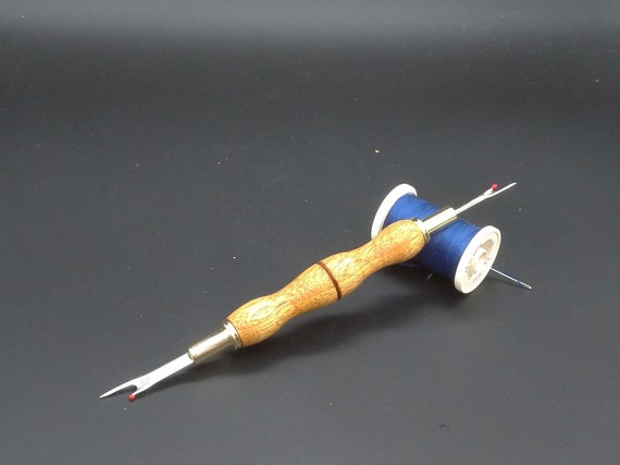 A Gold Plated Double Ended Seam Ripper With Emeri Wood Handle