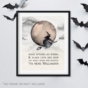 May include: A framed Halloween print featuring a witch on a broom flying in front of a full moon. The text reads, "When witches go riding & black cats are seen, the moon laughs and whispers 'tis near Halloween."