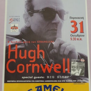 May include: A concert poster for a Hugh Cornwell show. The poster features a black and white photo of Hugh Cornwell wearing sunglasses. The text on the poster is in Greek and English. The poster is for a show on October 31st at 9:30 PM. The show is sponsored by Camel Music.