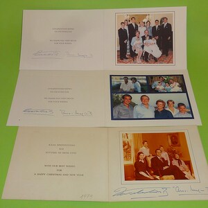 May include: Greeting cards with family photos and handwritten messages. The cards have text in Greek and English, including "We thank you very much for your wishes" and "A Happy Christmas and New Year". The cards are signed.