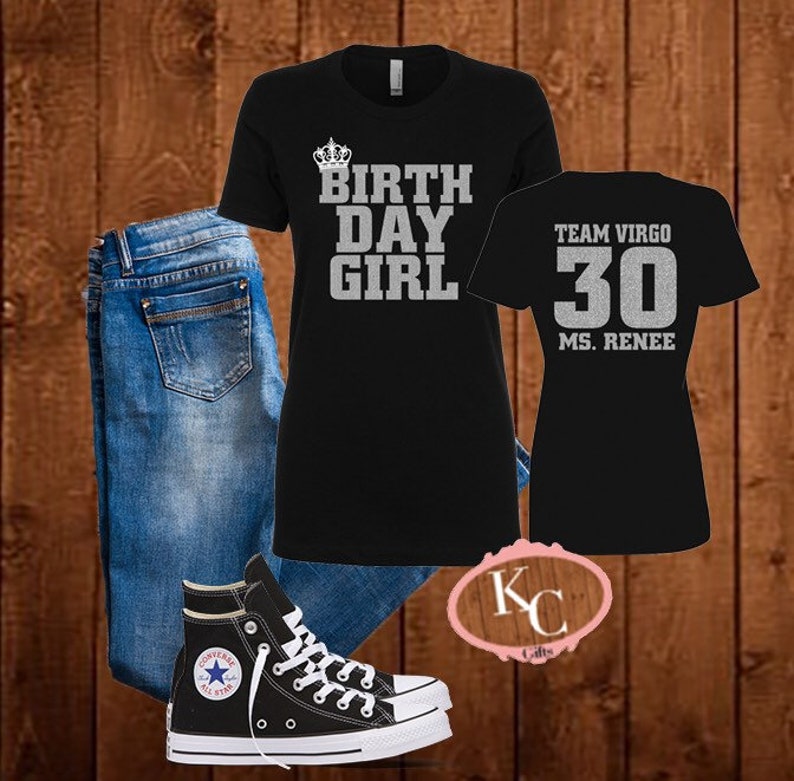 May include: Black t-shirt with silver glitter text that reads "BIRTHDAY GIRL" with a crown above the word "BIRTHDAY". A second black t-shirt with silver glitter text that reads "TEAM VIRGO 30 MS. RENEE". A pair of blue jeans and black high-top sneakers.