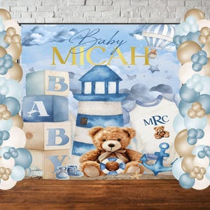 May include: A blue and white baby shower backdrop with a lighthouse, teddy bear, and blocks that spell out "Baby Micah". The backdrop is decorated with gold stars and clouds. There are blue and gold balloons on either side of the backdrop.