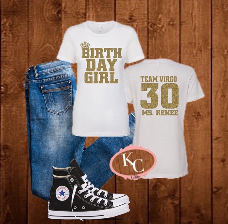 May include: White t-shirt with gold glitter text that says "Birthday Girl" with a crown above the text. A second white t-shirt with gold glitter text that says "Team Virgo 30 Ms. Renee". Blue jeans and black high-top sneakers.