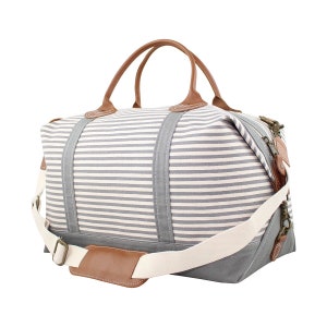 May include: A striped canvas travel bag with brown leather handles and trim. The bag has a long shoulder strap with a brown leather pad.