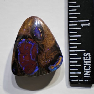Large triangular Boulder opal with purple and green fire veins---38.73 cts