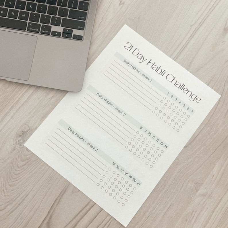 May include: A printable 21-day habit tracker with a light gray background. The tracker is divided into three weeks, with each week having a section for daily habits and a grid of circles for tracking progress. The text "21 Day Habii Challenge" is at the top of the page.