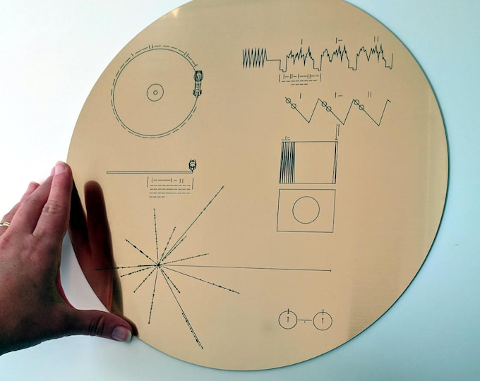 Full size replica of NASA Voyager Golden Record cover, laser engraved on golden metallic laminate. Celebrate the Voyager missions!