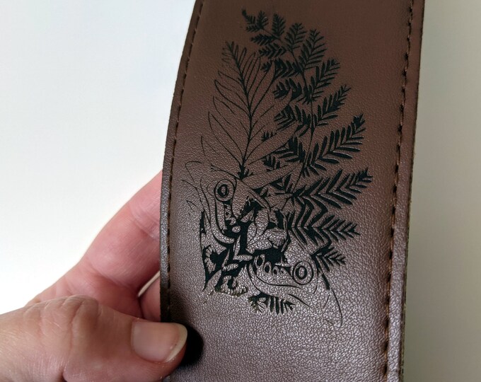 Custom engraved leather guitar strap, laser engraved with your choice of text and/or images. Brown leather Fender strap. TLOU
