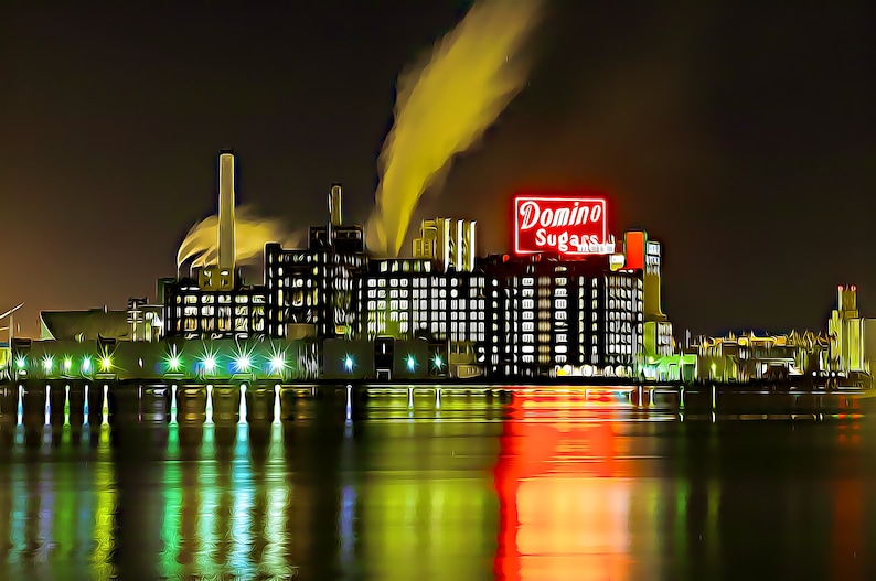 May include: A nighttime view of a large industrial building with a red neon sign that reads "Domino Sugars". The building is illuminated by lights and there is smoke coming from the chimney.