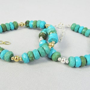 May include: Two turquoise and green beaded bracelets with gold and silver accents. The bracelets are made with faceted beads and have a chain clasp.