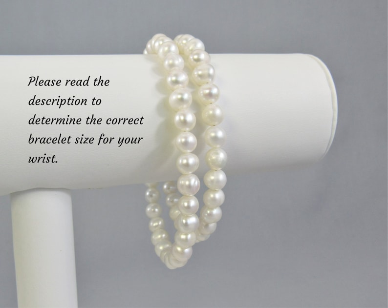 May include: Two white pearl bracelets shown on a white bracelet stans. Please read the description to determine the correct bracelet size for your wrist.
