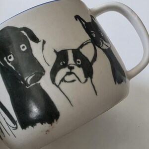 May include: A white ceramic mug with a black handle and the text "But First, Coffee" in a handwritten style. The mug is on a white surface. The mug is 4 inches tall.