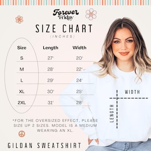 May include: Size chart for a Gildan sweatshirt with measurements in inches. The chart shows the length and width of the sweatshirt in sizes S, M, L, XL, and 2XL. The text "*FOR THE OVERSIZED EFFECT, PLEASE SIZE UP 2 SIZES. MODEL IS A MEDIUM WEARING AN XL." is included below the chart.