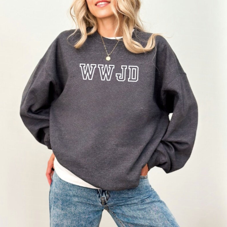 May include: A dark gray sweatshirt with the text "WWJD" in white outlined letters.
