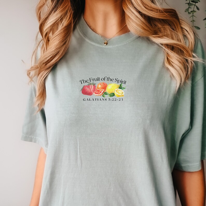 May include: A light blue t-shirt with a graphic of fruit and the text "The Fruit of the Spirit" and "GALATIANS 5:22-23".