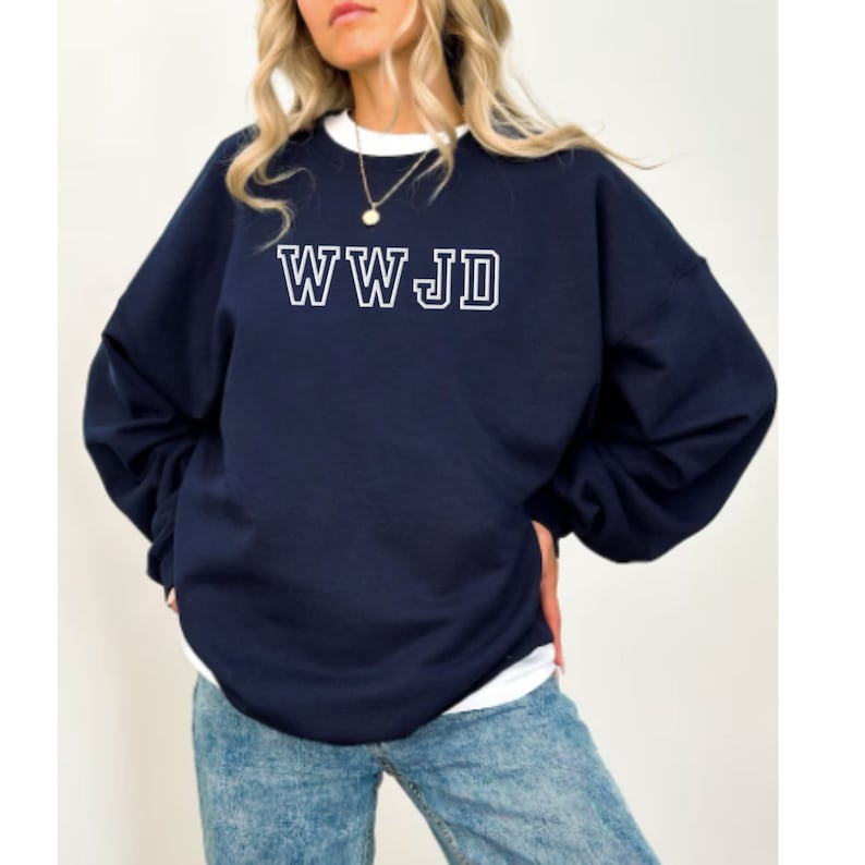May include: A navy blue sweatshirt with the text "WWJD" in white outlined letters.
