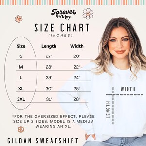 May include: Size chart for a Gildan sweatshirt with measurements in inches. The chart shows the length and width of the sweatshirt in sizes S, M, L, XL, and 2XL. The text *For the oversized effect, please size up 2 sizes. Model is a medium wearing an XL.* is also included.