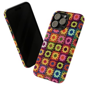 May include: A colourful phone case with a crocheted pattern in shades of pink, green, yellow, blue, and brown. The case has a black border and a cutout for the phone's camera.
