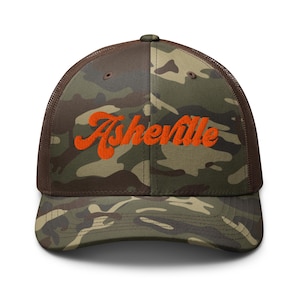 May include: A camouflage trucker hat with an orange embroidered "Asheville" logo.