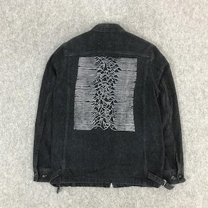 May include: A dark grey denim jacket featuring a white graphic on the back. The graphic is a linear representation of a mountain range. The jacket has a button-down front, two chest pockets, and adjustable waist tabs.