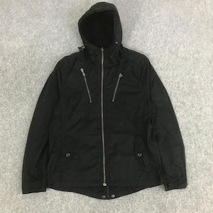 May include: A black hooded jacket featuring a full-length front zipper, two diagonal zippered chest pockets, and two lower pockets with buttoned flaps. The jacket includes a drawstring hood and long sleeves with cuffs, providing a functional design.