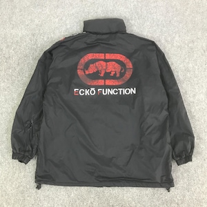 May include: A black jacket featuring a high collar and long sleeves with elastic cuffs. The back displays a large red distressed graphic of a rhinoceros inside an oval frame, with the white text ECKO FUNCTION printed directly below the logo.