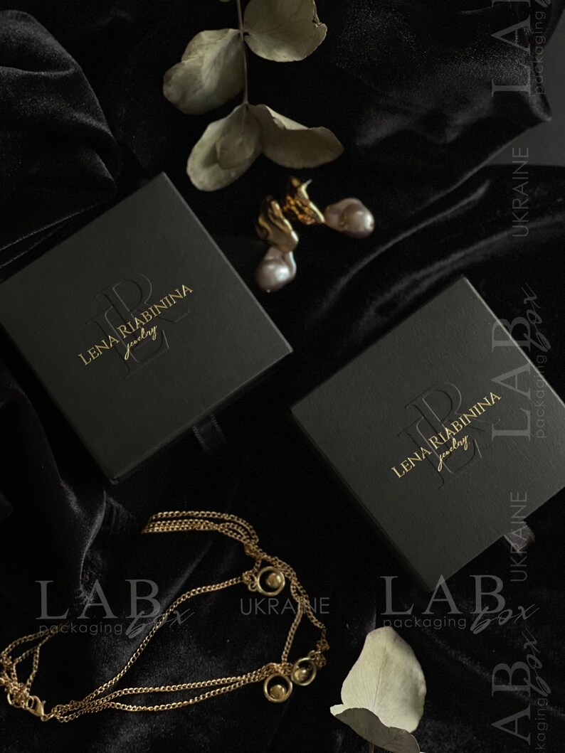 May include: Two black jewelry boxes with gold lettering that reads "LENA RIABININA jewelry" on a black velvet background. The boxes are labeled "LABox packaging" and "UKRAINE".