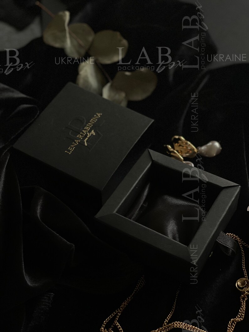May include: Black jewelry box with a gold logo that reads "Lena Riabininia Jewelry" and the text "LAB packaging box UKRAINE".