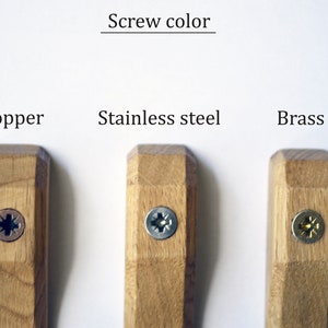 May include: Three wooden hooks with different colored screws. The screws are copper, stainless steel, and brass.