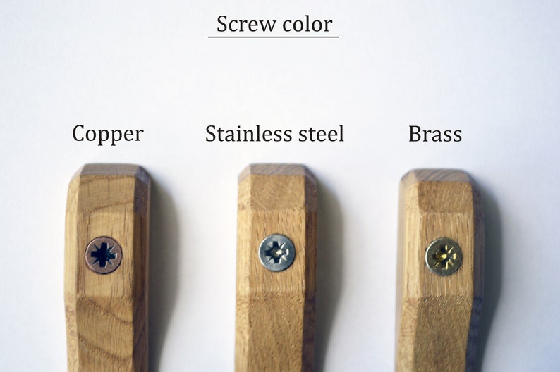 May include: Three wooden hooks with different colored screws. The screws are copper, stainless steel, and brass.