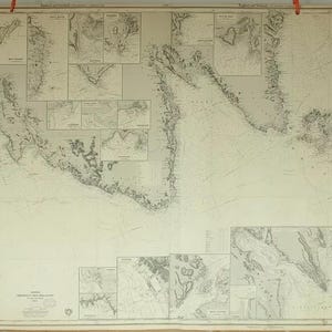 May include: A vintage nautical chart of the coast of Maine, featuring detailed lines and markings indicating depths, shoals, and other navigational features. The chart is printed on a large sheet of paper and is in good condition.