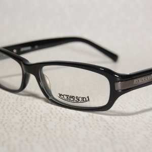 Oanvända JECKERSONS svarta rektangulära låga linsbågar i plastacetat med optiska bågar